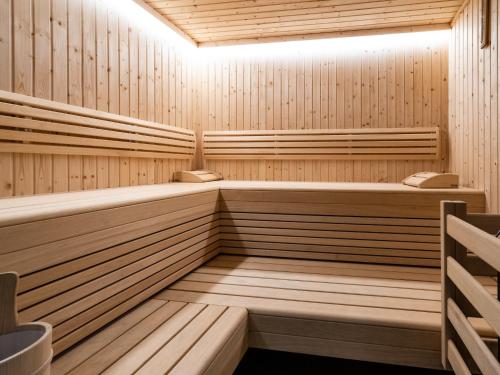 a wooden sauna with two benches in it at Chalet in Zell am See near Ski Slopes in Bruck an der Großglocknerstraße