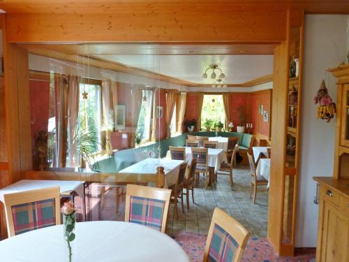 a dining room with white tables and chairs at Landgasthof-Hotel-Rössle in Oberprechtal