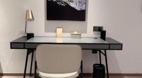 a black desk with a white chair and a lamp at Atour Hotel Jinan Tangyan Century Avenue in Jinan