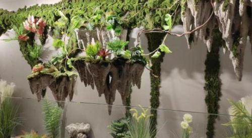 a group of plants hanging on a wall at Atour Hotel Jinan Tangyan Century Avenue in Jinan