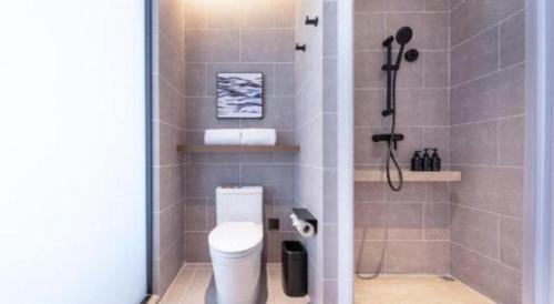 a bathroom with a shower and a toilet in it at Atour Hotel Jinan Tangyan Century Avenue in Jinan