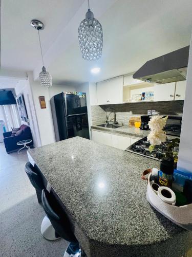 a kitchen with a table and a counter top at apartment in Condesa Caracol Acapulco in Acapulco