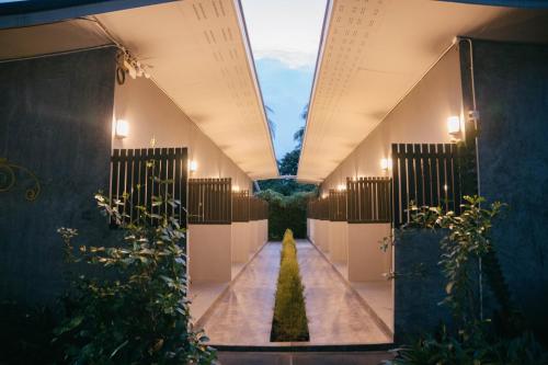 a hallway of a building with plants in it at The Target Hotel chaingrai in Chiang Rai