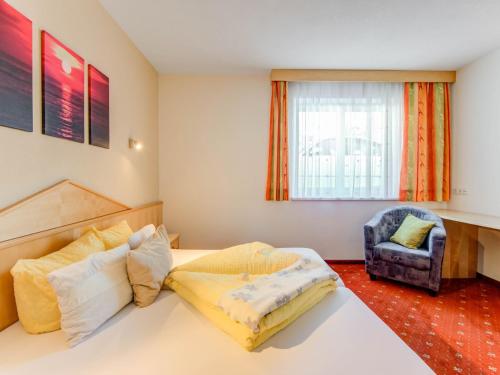 a bedroom with a bed and a chair at Apartment in Tyrol in an attractive area in Fiss