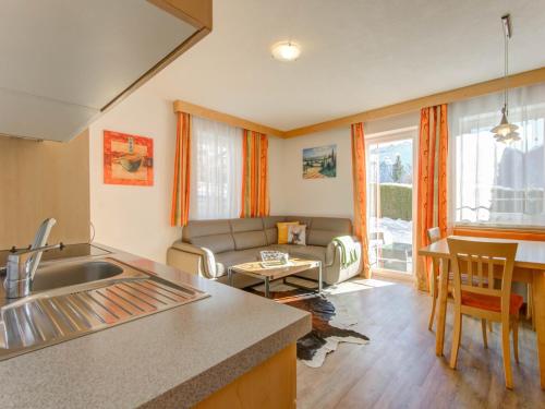 a kitchen and a living room with a couch at Apartment in Tyrol in an attractive area in Fiss