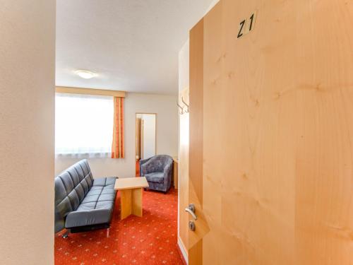 a room with a couch and a table and a door at Apartment in Tyrol in an attractive area in Fiss
