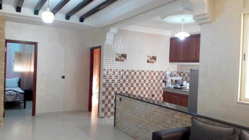 a living room with a kitchen with a counter top at Reem in Temara