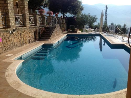 a large swimming pool with blue water at La Fonte Su in Canterano