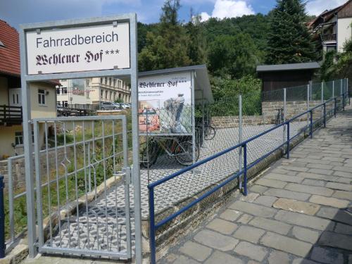 a fence with a sign in front of a building at Hotel Wehlener Hof in Stadt Wehlen