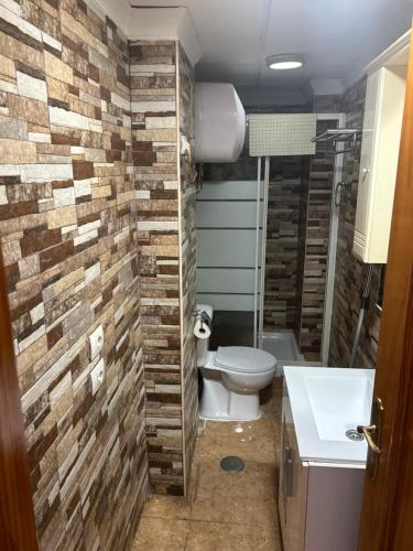 a bathroom with a toilet and a sink at Apartamento Las Canteras in Las Palmas de Gran Canaria