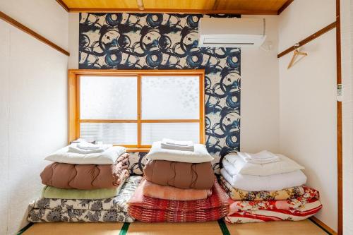 a room with two bean bags in front of a window at 温泉徒歩30秒 一棟貸切で最大15名まで 広々キッチンで自炊可 in Iwaki
