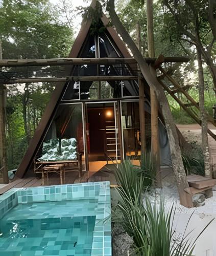 a small house with a pool in front of it at Espaço Gaia in Santana do Riacho