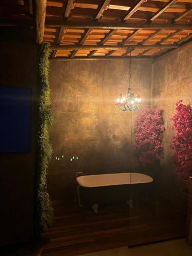 a room with a table and flowers on the wall at Espaço Gaia in Santana do Riacho
