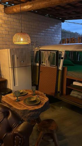 a table with a plate of food and a van at Espaço Gaia in Santana do Riacho