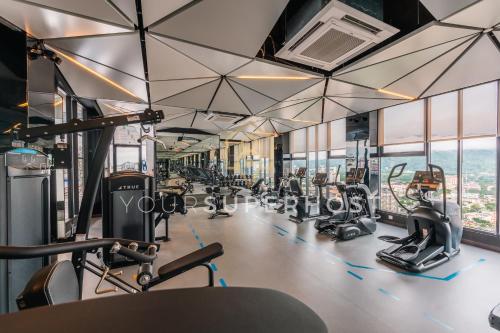 a gym with treadmills and elliptical machines at 22 Macalisterz by YourSuperhost in George Town