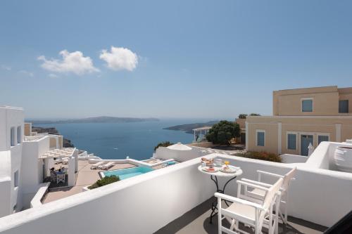 a balcony with a view of the water at Aria Suites & Villas in Fira