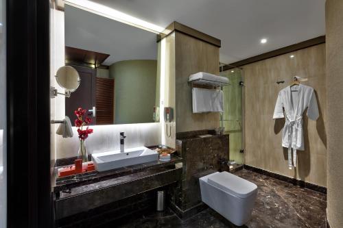 a bathroom with a sink and a mirror at The Atara in Gurgaon