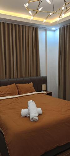 a bed with two white towels on top of it at D'Cozystay home vacation in San Jose del Monte