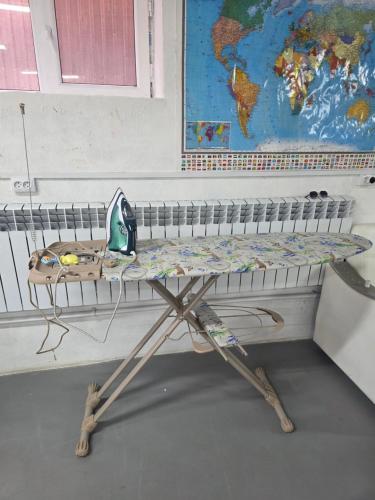 a table in a classroom with a map on the wall at Kushtar in Bishkek