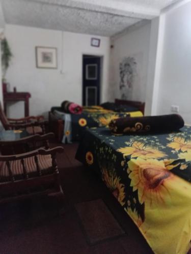 a room with two beds and a table and chairs at Silonya Forest Edge in Nuwara Eliya