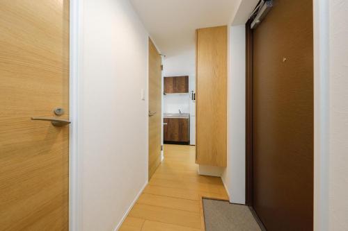 a hallway with a door leading to a kitchen at Oakville Nezu by Tranova in Tokyo