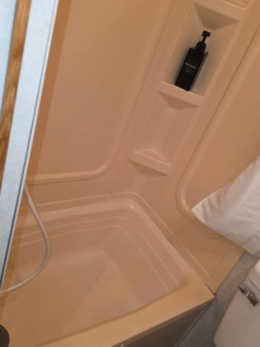 a bathroom door with a bottle of wine in it at Fifth wheel in Kelso
