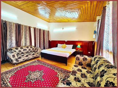 a bedroom with a bed and a couch at HOTEL You & Me Near Mall Road & NAINI LAKE - Free Wifi & Room Service With Parking Facilities - Hygiene and Spacious Room - The Best Hotel with Mountain Views - Best Hotel In Nainital in Nainital