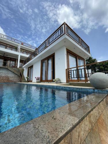 a house with a swimming pool next to a building at Tangalle Villa in Tangalle