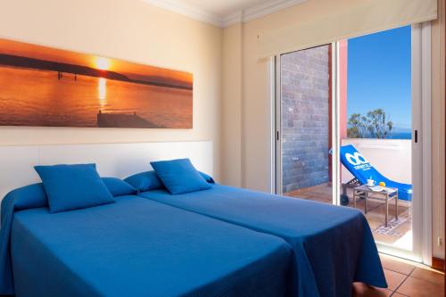 Postel nebo postele na pokoji v ubytování Apartamentos Terrazas Los Gigantes by Suncanarias