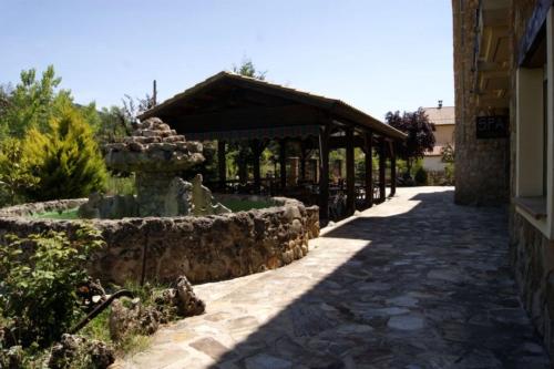 a stone walkway with a fountain in front of a building at Hotel Riopar Spa in Riópar