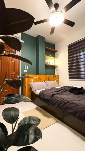 a bedroom with a bed and a ceiling fan at Pa-Hinga Kaliwa Homey Japandi Studio Retreat in Baler