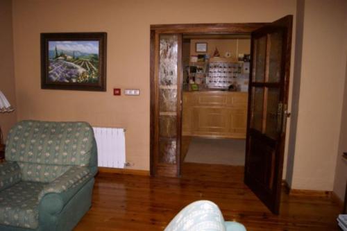 a living room with a couch and an open door at Hotel Riopar Spa in Riópar