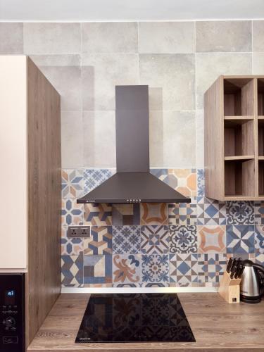 a kitchen with a stove top oven in a kitchen at Hayat Apartments & Homes in Lagos