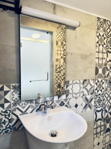 a bathroom with a sink and a mirror at Hayat Apartments & Homes in Lagos