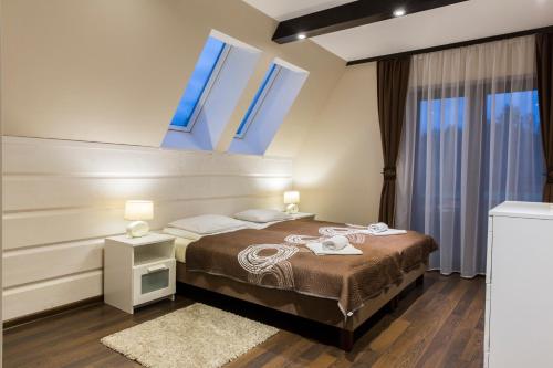 a bedroom with a bed with blue lights on it at Quality House - Cisza nad Doliną in Zakopane