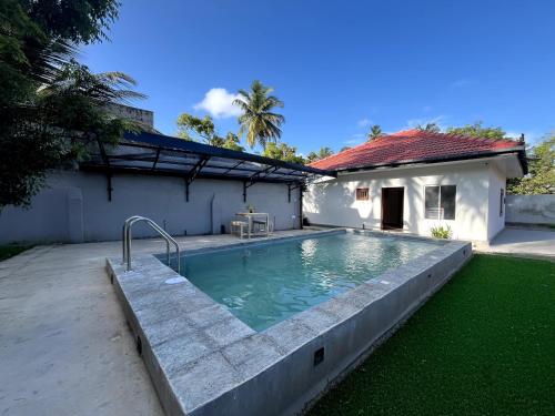 a swimming pool in the backyard of a house at Villa Wansha in Rathgama