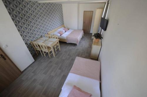 a small room with a bed and a table at Apartmány na kolonádě in Lednice