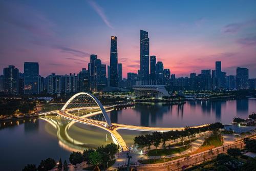 a view of a city with a bridge over a river at Meipeng Light Luxury-Olympic Sports Center International Financial City Store in Guangzhou