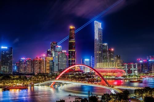 a city skyline at night with a bridge and buildings at Meipeng Light Luxury-Olympic Sports Center International Financial City Store in Guangzhou