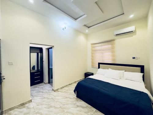 a bedroom with a bed in a room with a window at Hayat Apartments & Homes in Lagos
