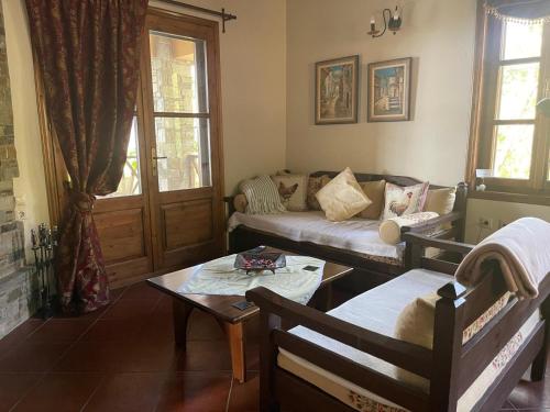 a living room with a couch and a table at Matias Kastanies 2 Appartements with privat parking in Mikros Prinos