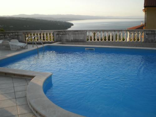a large blue swimming pool on top of a building at Villa Antonio in Opatija