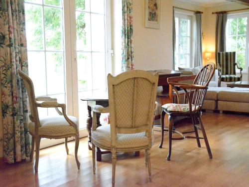 a living room with chairs and a table and a couch at Spacious villa near Lesse in Daverdisse