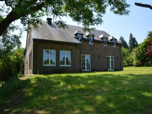 a large brick house on a grass field at Spacious villa near Lesse in Daverdisse