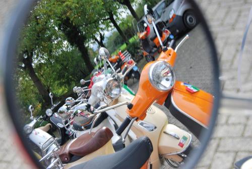 a mirror of a group of motorcycles parked on the street at Hotel De Oude Brouwerij in Mechelen