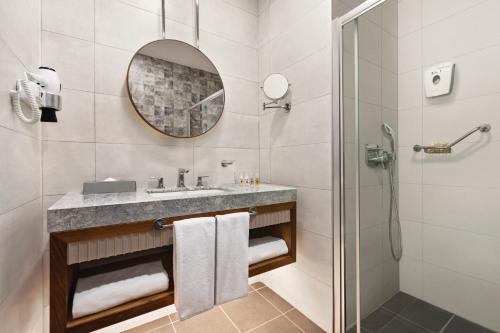a bathroom with a sink and a shower at Tryp by Wyndham Istanbul Topkapi in Istanbul