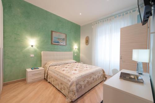 a bedroom with a bed and a desk in it at Guest House Le Tre Spezie in La Spezia