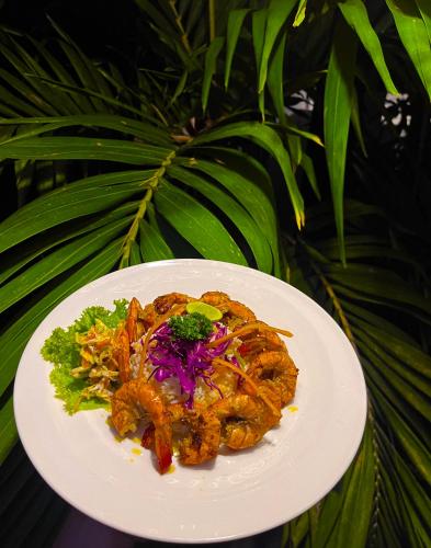 a white plate of food on a table at Sundaras Infinity Jungle Resort in Dambulla