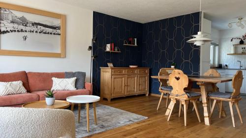 a living room with a couch and a table at Haus Allod 208 in Lenzerheide