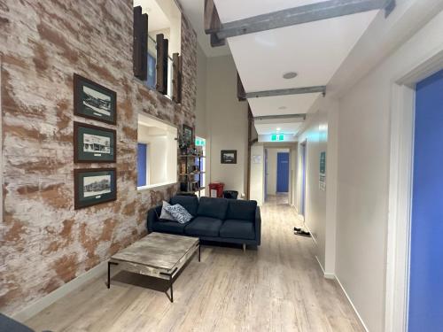 a living room with a couch and a table at Global Backpackers Cairns in Cairns